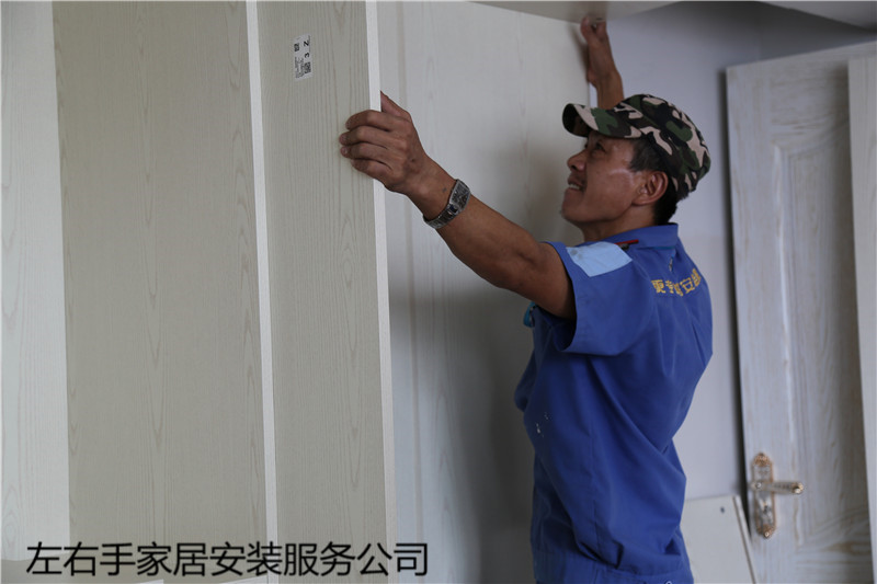 左右手衣柜安裝師傅正在進(jìn)行衣柜門(mén)安裝